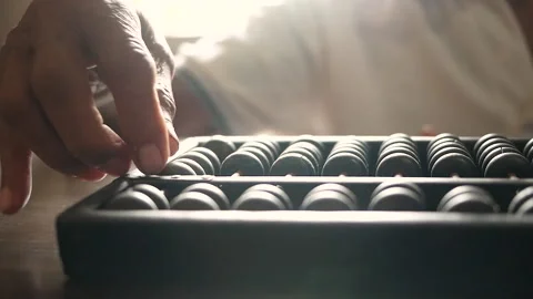 Close up of senior hand using chinese abacus or old antique calculator on table Stock Footage 138079827