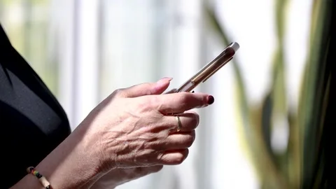 Close-up of senior hands using mobile phone Stock Footage 347170653