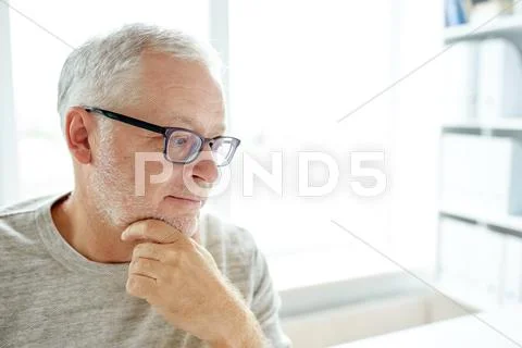 Close up of senior man in glasses thinking Stock Photos