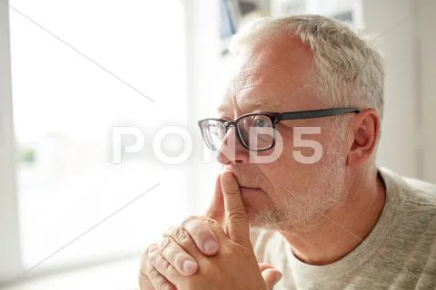 Close up of senior man in glasses thinking Stock Photos
