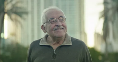 Close-up of senior man looking around a park and smiling Stock Footage 234529476