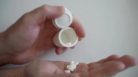 Close up senior man opening bottle of medication, pouring pills into hand Stock Footage 275474081