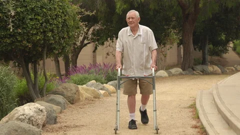 Close up of senior walking in the park using a walker Vídeos de archivo 153629148
