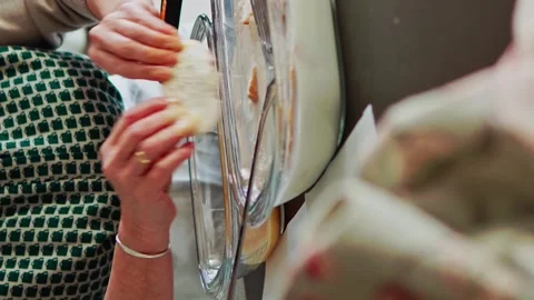 Close up of senior woman soaking bread with sweet milk and cinnamon. Stock Footage 264183468