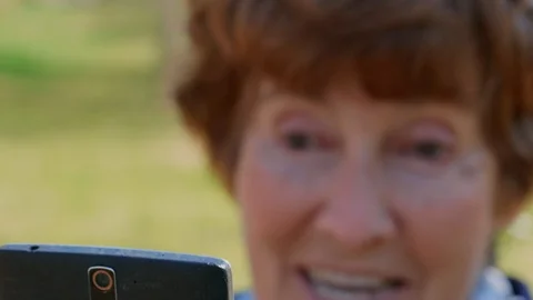 Close-up of senior woman talking via mobile video, emotions Video stock 106941890