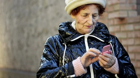 Close up of senior woman using mobile phone outdoor Video stock 42948405