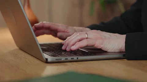 Close-up of senior womans hands typing on laptop Stock Footage 307417251