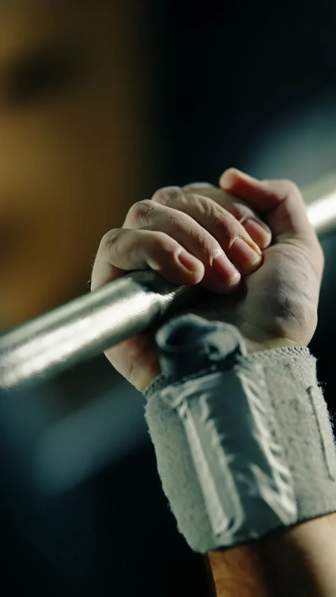 Close-up sequence of an athletes chalked hands approaching and gripping a Stock-Footage 329556120