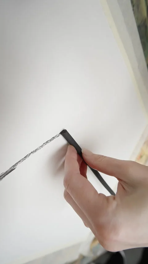 Close-up sequence capturing a hand using charcoal to draw a textured line on Stock Footage 333128759