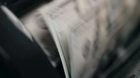 Close-up sequence of cash being processed through a currency counting machine, Stock Footage 333979001