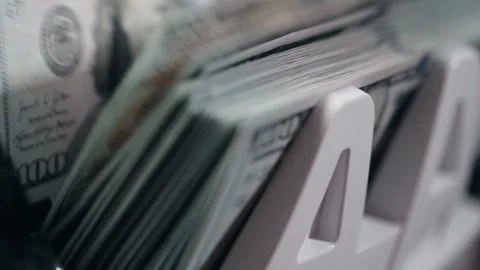 Close-up sequence of cash counting machine processing stacks of hundred-dollar Stock Footage 333978863