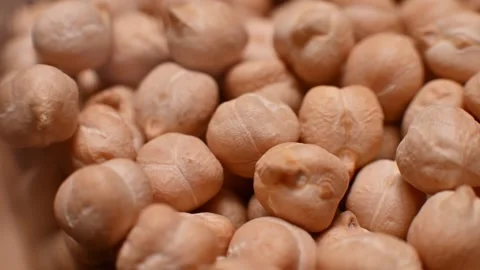Close-up sequence of dried chickpeas in a glass container, showcasing their Stock Footage 330487053