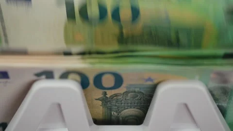Close-up sequence of euro banknotes being processed in a currency counting Stock Footage 333979012