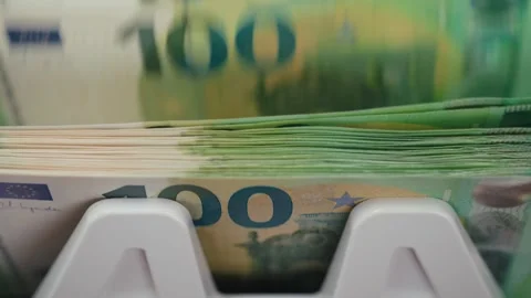 Close-up sequence of euro banknotes being processed through a currency counting Stock Footage 333979063