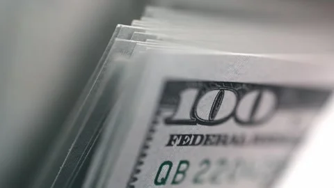Close-up sequence of hundred-dollar bills fanned out, showcasing intricate Stock Footage 331080212
