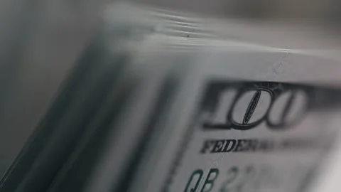 Close-up sequence of hundred-dollar bills fanned out, showcasing intricate Stock Footage 331080234