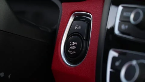 Close-up sequence of modern vehicle ignition button being activated, showcasing Stock Footage 329565254
