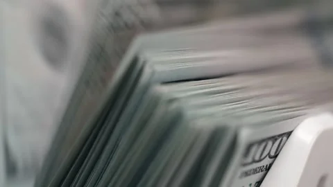 Close-up sequence of stacked hundred-dollar bills in a cash drawer, showcasing Stock Footage 333979061