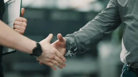 Close-up sequence of two professionals concluding a meeting with a confident Video stock 335860366