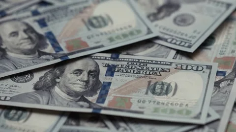 Close-up sequence of US dollar banknotes stacked together, showcasing intricate Stock Footage 327698807