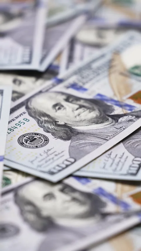 Close-up sequence of U.S. dollar bills stacked together, showcasing intricate Stock Footage 328124713