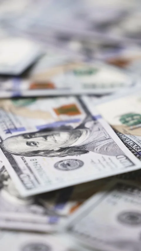 Close-up sequence of US dollar bills stacked in a disorganized manner, Stock Footage 328124741