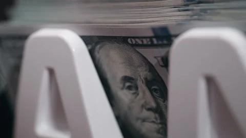 Close-up sequence of US dollar bills stacked in a white money holder, showcasing Stock Footage 333979212