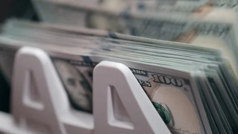Close-up sequence of US dollar bills being organized in a white money holder, Stock Footage 333979267