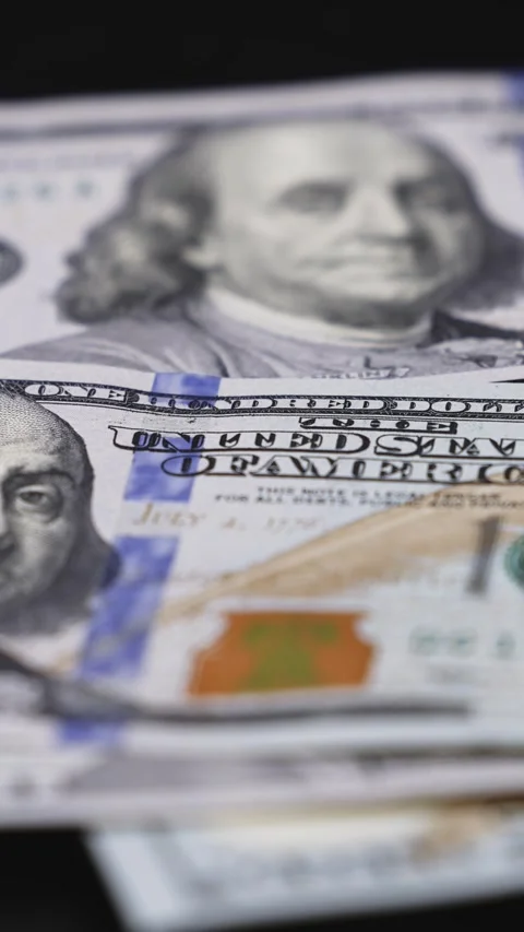 Close-up sequence of US hundred-dollar bills being arranged on a black surface, Stock Footage 328124763