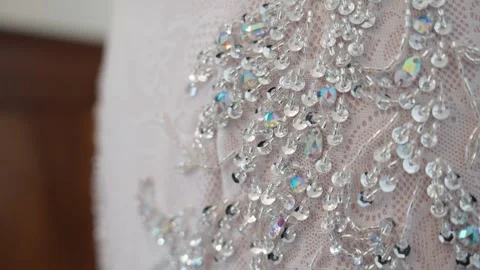 Close-up of sequins and crystal embroidery on a white dress Stock Footage 332310613