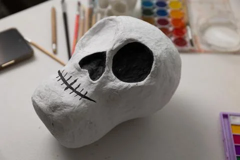 Close-up series image of a handmade Day of the Dead skull in progress, showin Stock Photos