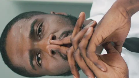 Close up of serious businessman thinking of a problem solution. Vertical video Stock Footage 131784365