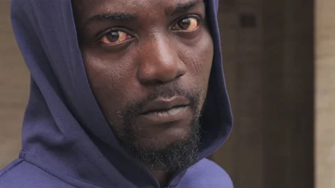 Close up serious face black man looking at camera stand on street in the city Stock Footage 218614196