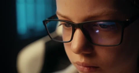 Close up of serious focused face of smart teenage girl wearing glasses to Video stock 157644955