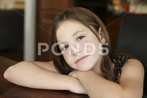 Close up of serious girl resting chin on hand Stock Photos