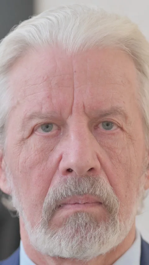 Close up of Serious Old Man Face, vertical video 動画素材 325565388