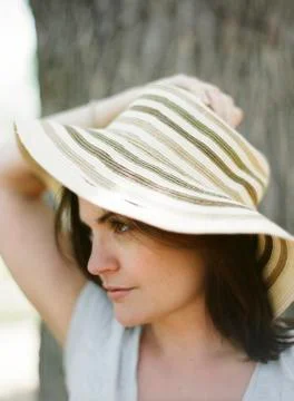 Close up of serious woman wearing sun hat Stock Photos