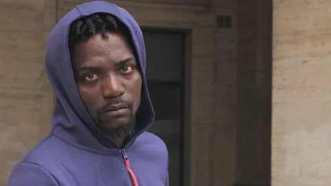 Close up on Serious young immigrant African staring at camera Stock Footage 218761182