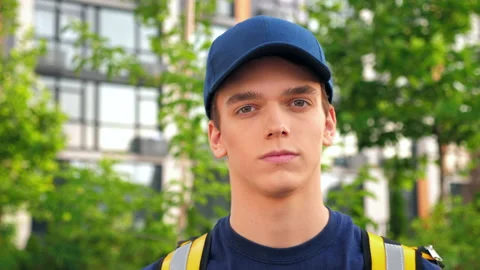 Close up serious young man courier delivery with thermal backpack looking camera Stock Footage 157256513