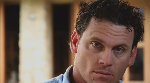 Close Up, seriously man looks to camera Stock Footage 38758321