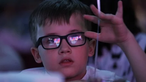 Close up seriously young pretty boy with glasses sitting looking blue light Video stock 98216089