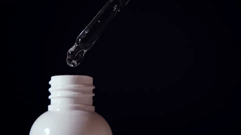 Close-up of serum drops falling from the pipette. Organic essence.  Stock Footage 151952074