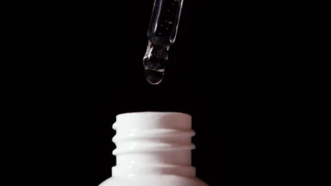 Close-up of serum drops falling from the pipette. Organic essence.  Stock Footage 152364180