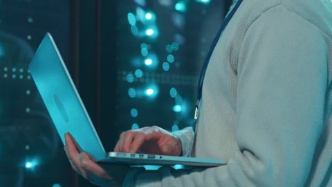 Close-up server administrator working on laptop providing webhosting diagnostics Stock Footage 119233469