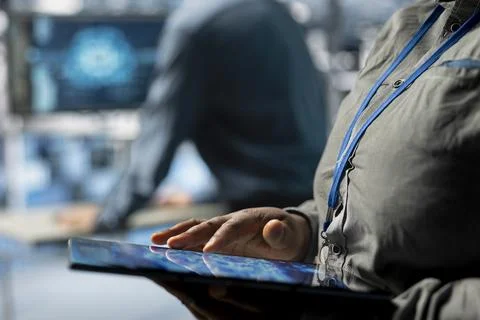 Close up of server farm IT expert using tablet to improve deep learning AI 스톡 사진
