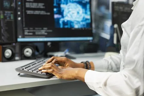 Close up of server farm worker typing on PC keyboard, deploying deep learning 写真素材