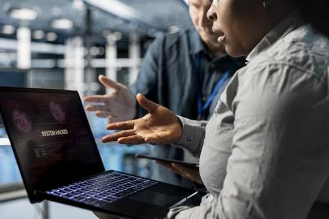 Close up of server room engineers working together to close hacker exploits Stock Photos