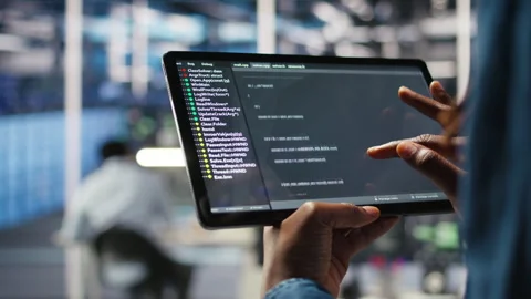 Close up of server room programmer checking coding on tablet Stock Footage 307017072