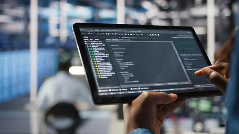 Close up of server room programmer checking coding on tablet Stock-Fotos