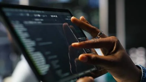 Close up of server room programmer checking coding on tablet Stock-Fotos